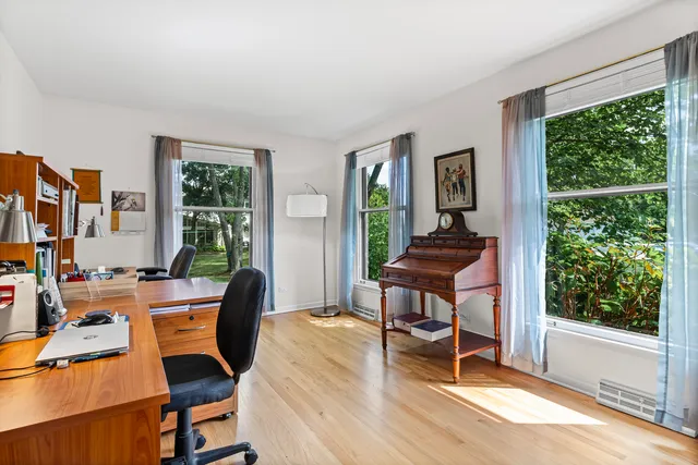 a view of a workspace with furniture and a window