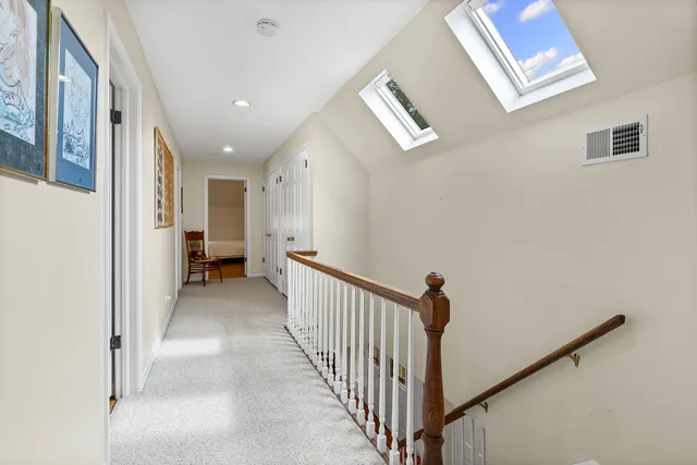 a view of a hallway with a window and a livingroom