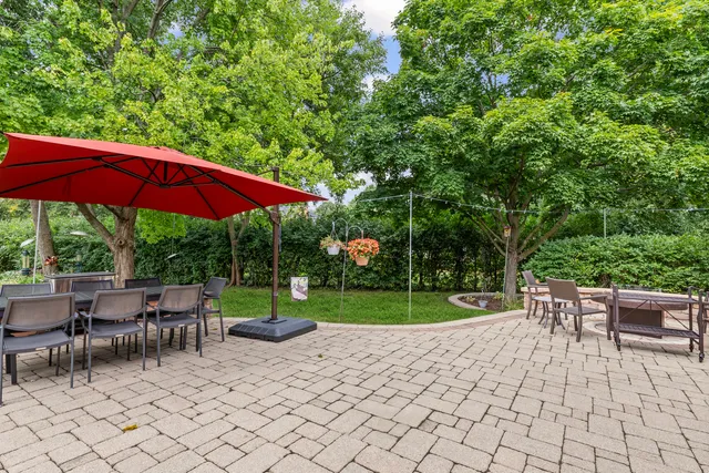 a view of backyard with seating and trees