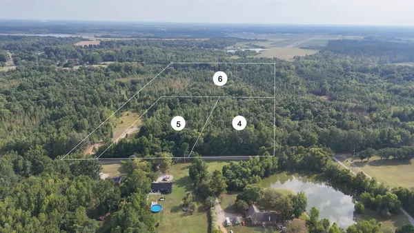 an aerial view of a house with a lake view