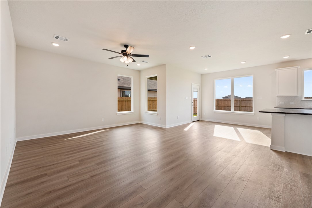 2415 Rooke Road Bryan, TX 77807 - Photo 12 of 36 a view of an empty room with window and wooden floor