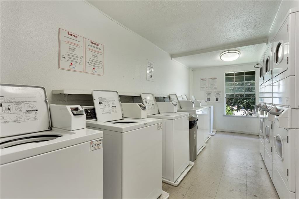 910 Duncan Lane, Unit 35 Austin, TX 78705 - Photo 20 of 20 Functional laundry room equipped with multiple machines, offering convenient on-site clothes care.