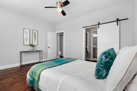 a bedroom with a bed and a dresser