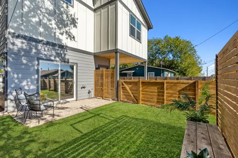 a view of a house with backyard and sitting area