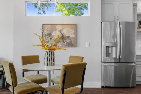 a view of a dining room with furniture and a window