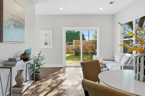 a living room with furniture and a floor to ceiling window