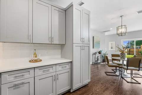 a kitchen with cabinets appliances and a counter space