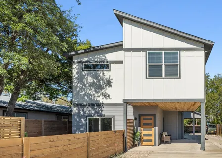 a view of a house with a tree