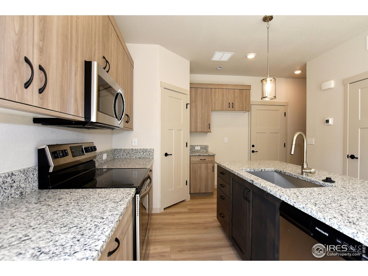 268 East 4th Street Berthoud, CO 80513 - Photo 12 of 39 a kitchen with stainless steel appliances granite countertop a sink stove and refrigerator
