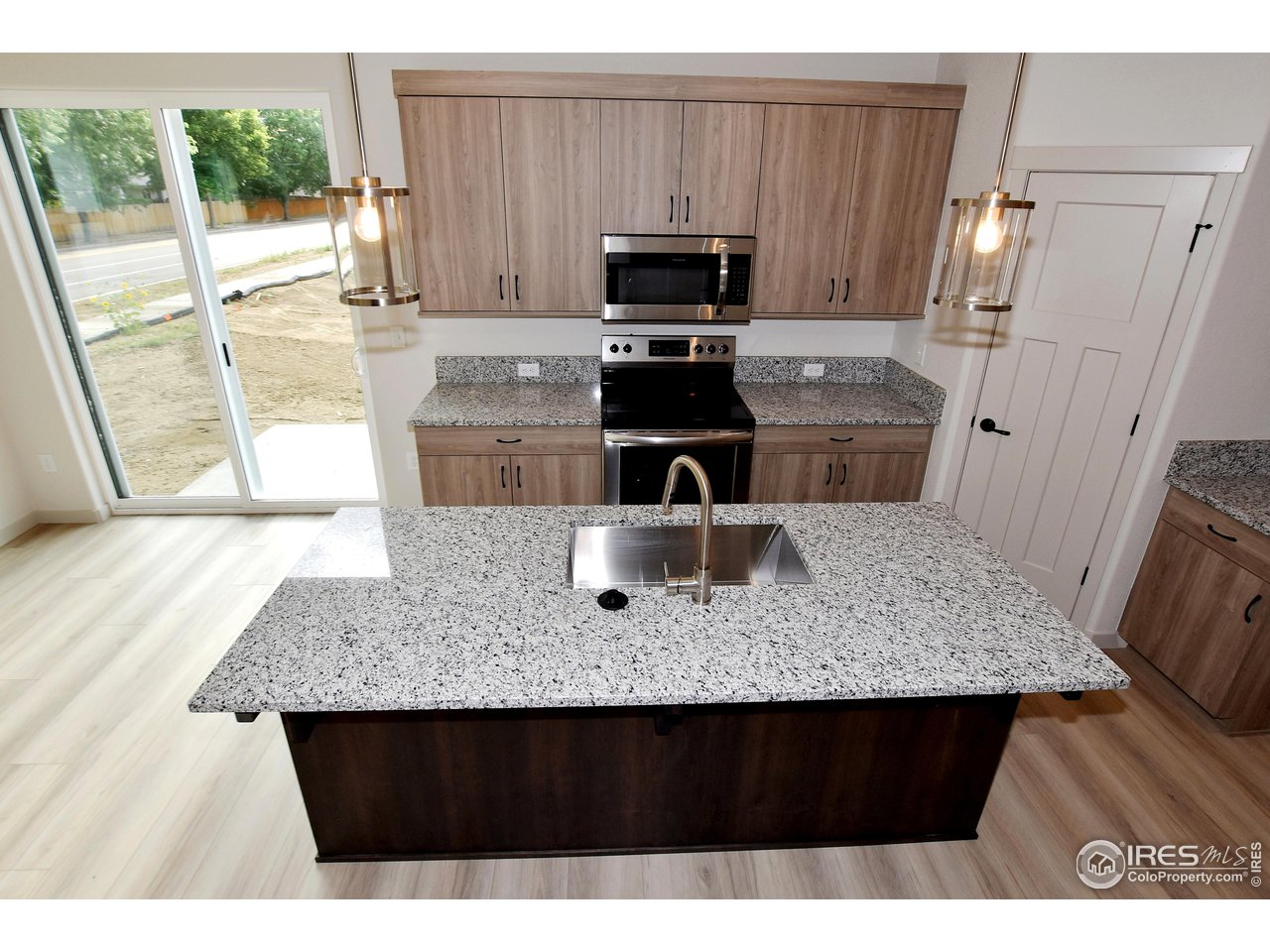268 East 4th Street Berthoud, CO 80513 - Photo 18 of 39 a kitchen with a sink refrigerator and microwave
