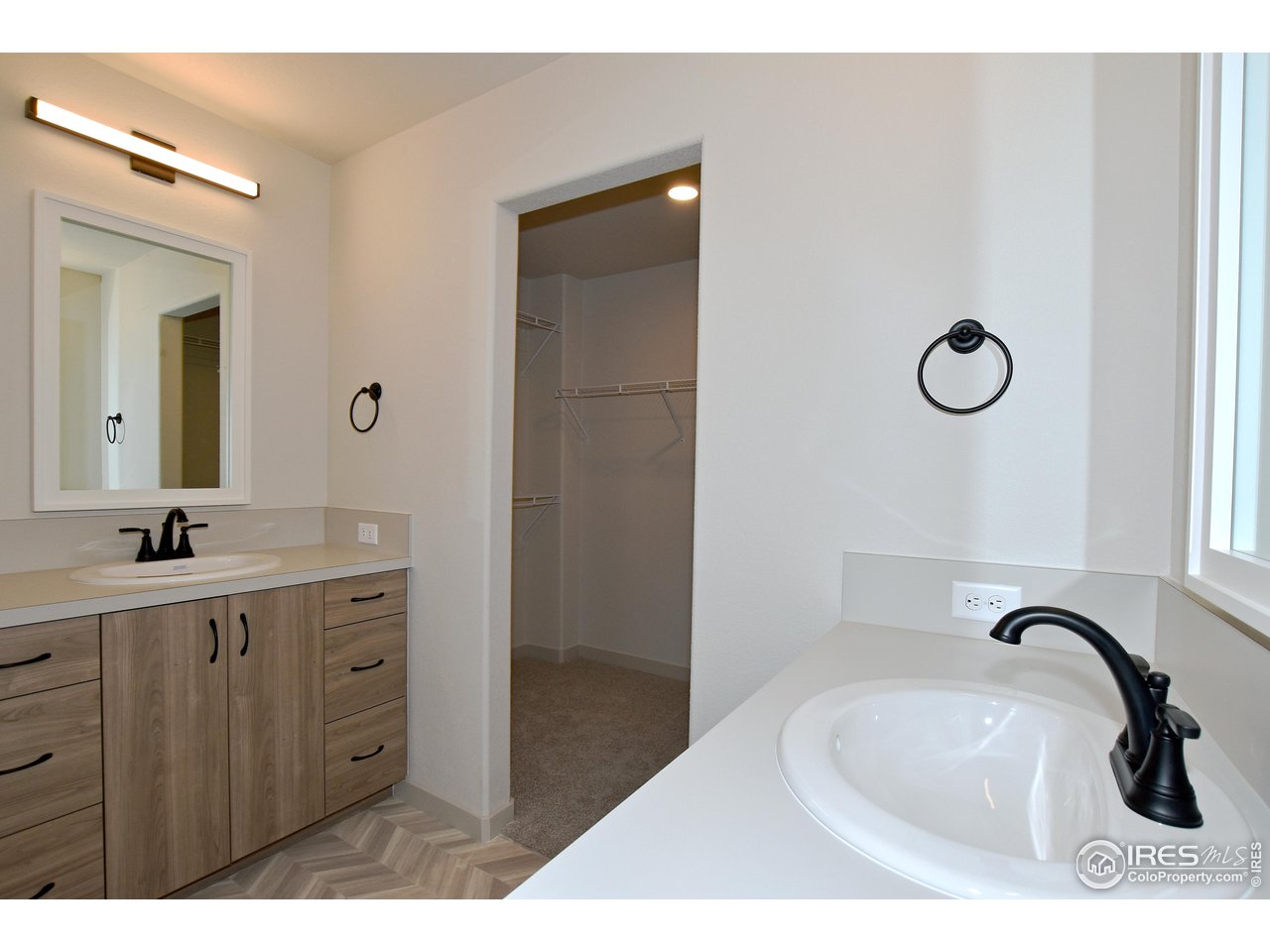 268 East 4th Street Berthoud, CO 80513 - Photo 23 of 39 a bathroom with a granite countertop sink a mirror and a shower
