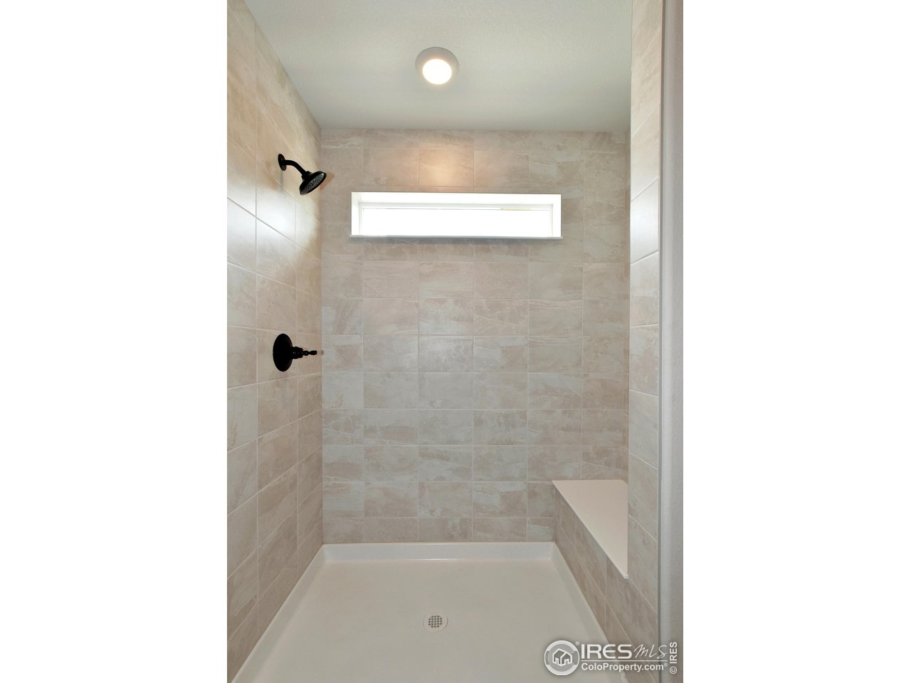 268 East 4th Street Berthoud, CO 80513 - Photo 26 of 39 a bathroom with a bathtub and shower