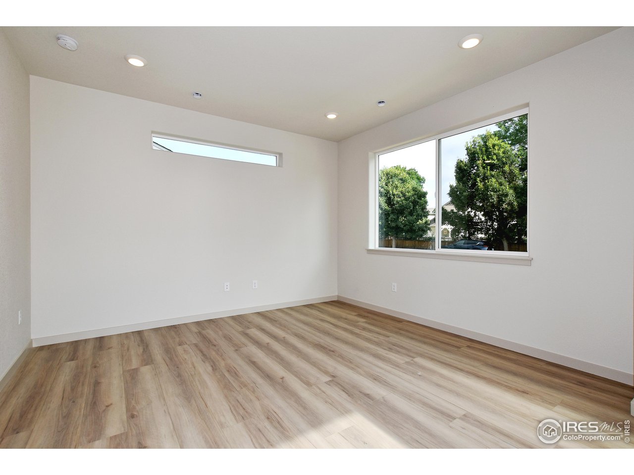 268 East 4th Street Berthoud, CO 80513 - Photo 6 of 39 a view of an empty room with wooden floor and a window