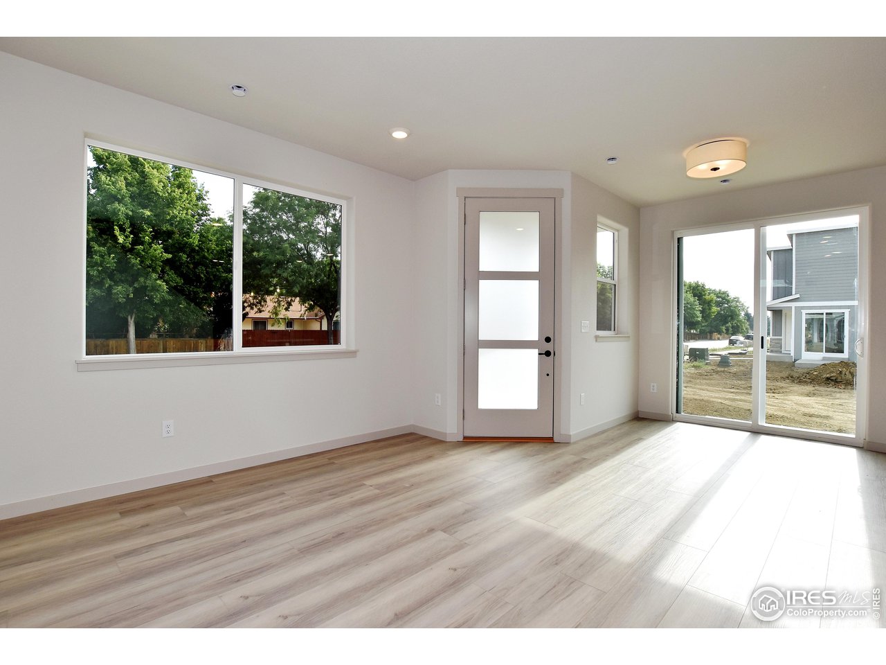 268 East 4th Street Berthoud, CO 80513 - Photo 7 of 39 a view of an empty room with glass door and wooden floor