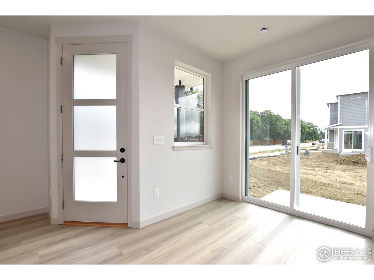268 East 4th Street Berthoud, CO 80513 - Photo 9 of 39 an empty room with wooden floor and windows