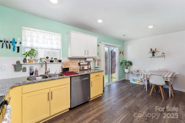 a kitchen with a table chairs refrigerator and microwave