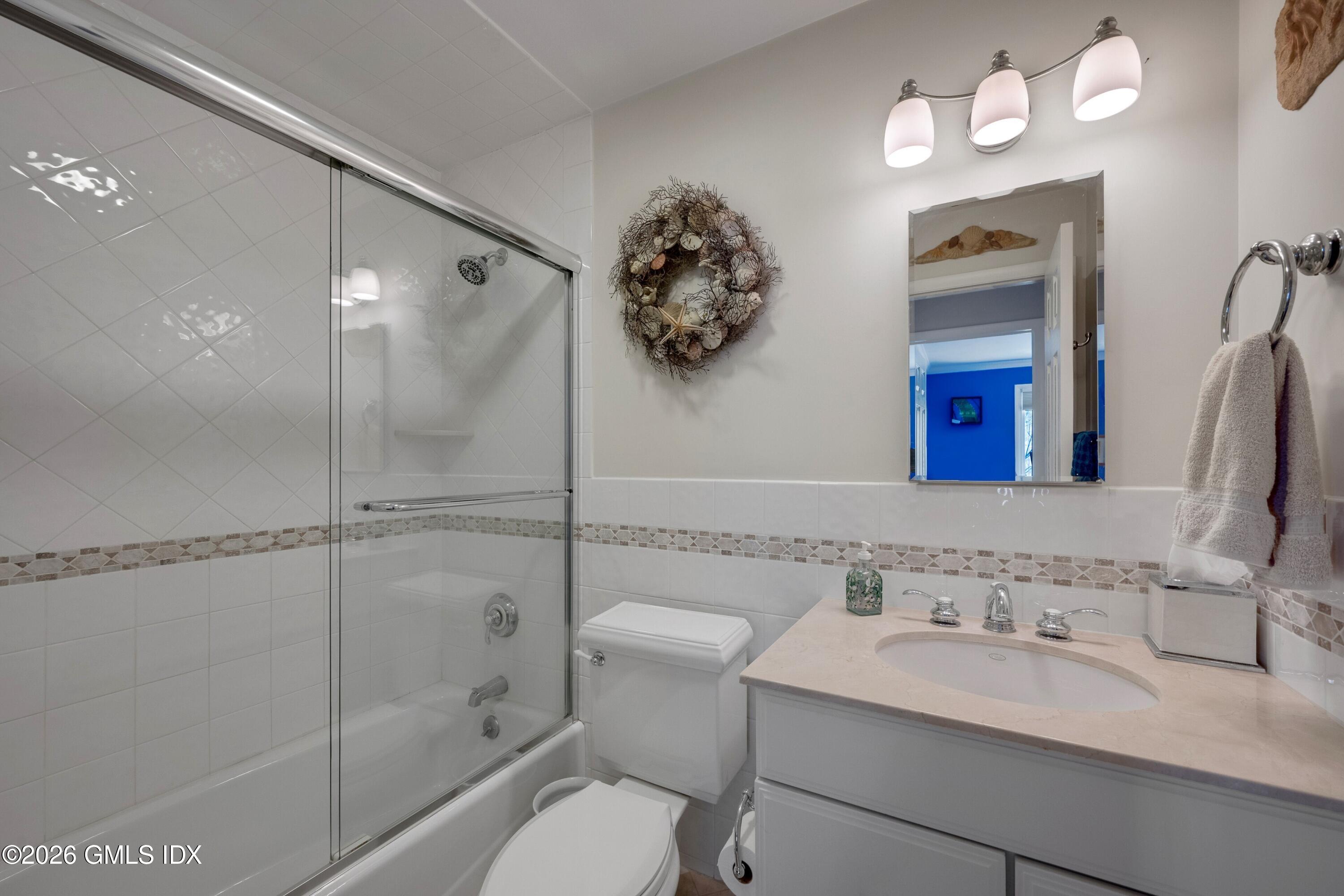 58 Stirrup Lane, Unit 58 Riverside, CT 06878 - Photo 11 of 23 a bathroom with a sink a toilet and a mirror