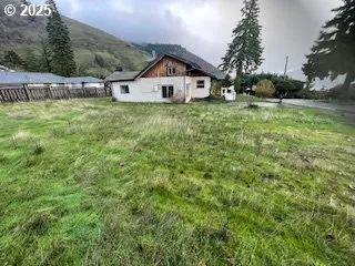 a view of a house with a yard and sitting area