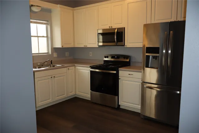 a kitchen with a refrigerator stove and microwave