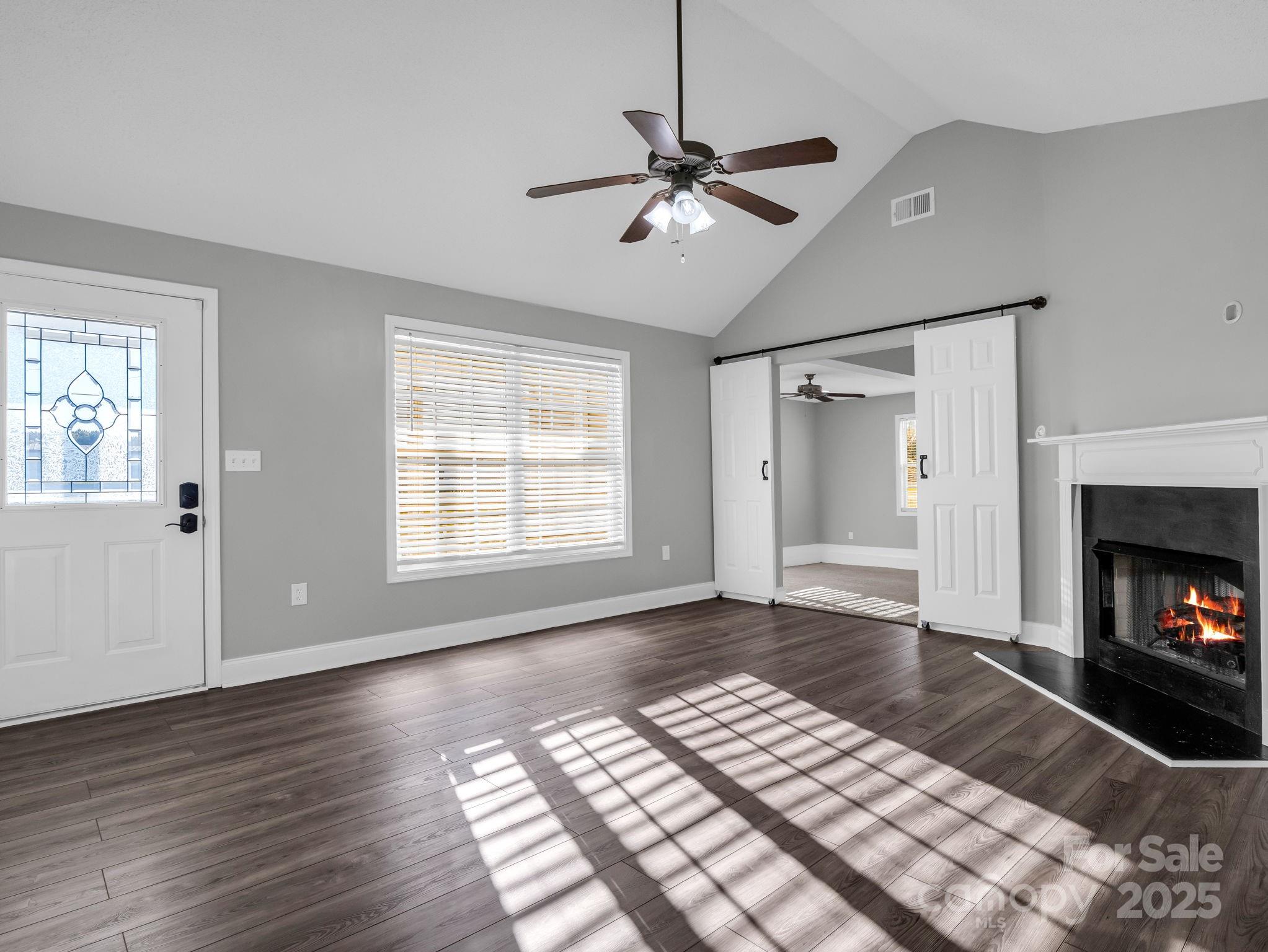 340 Sarratt Creek Road Gaffney, SC 29341 - Photo 18 of 46 a view of an empty room with wooden floor fireplace and a window