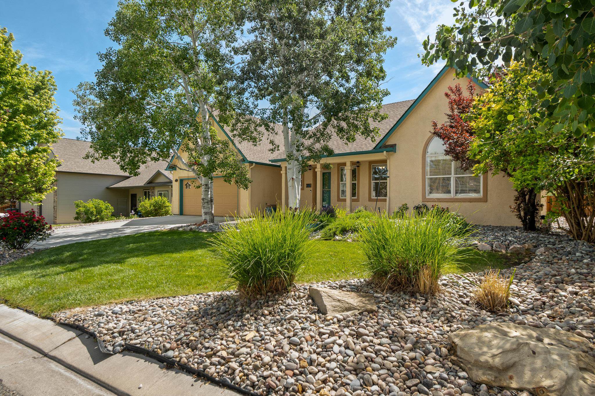 398 Butte Court Grand Junction, CO 81507 - Photo 3 of 33 a front view of a house with garden
