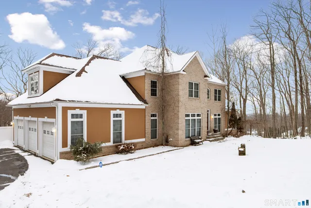 a view of a house with snow on the road