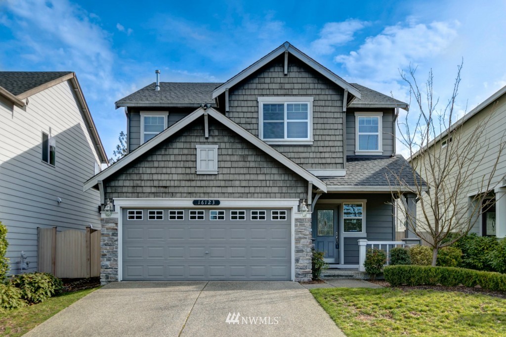 16123 35th Drive Southeast Bothell, WA 98012 - Photo 1 of 13 a front view of a house with a garden