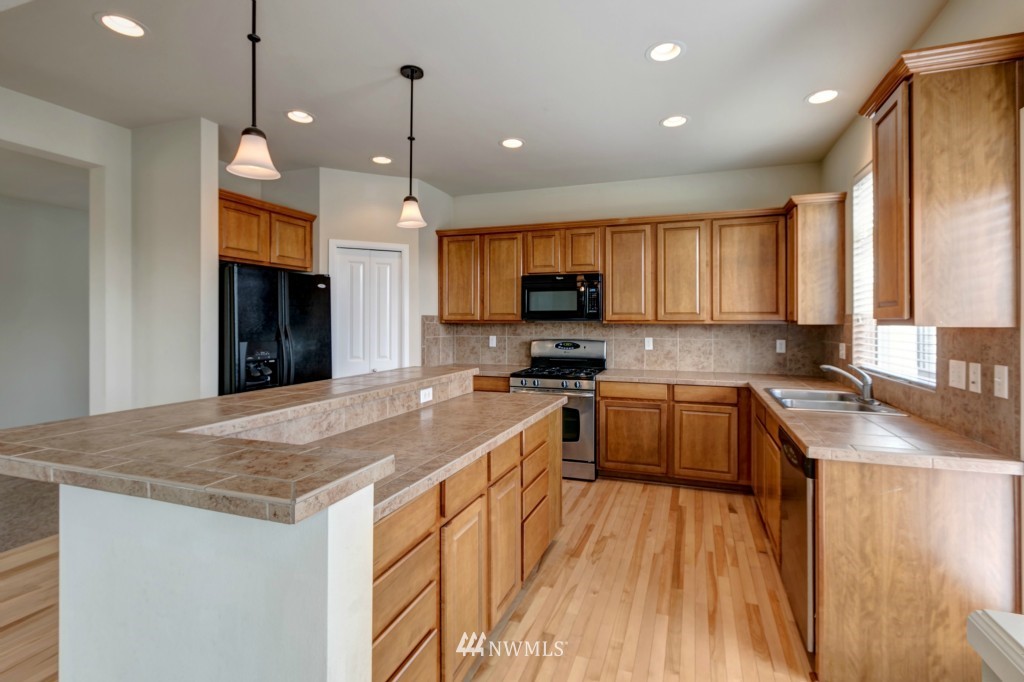 16123 35th Drive Southeast Bothell, WA 98012 - Photo 2 of 13 a kitchen with granite countertop a sink a counter top space appliances and cabinets