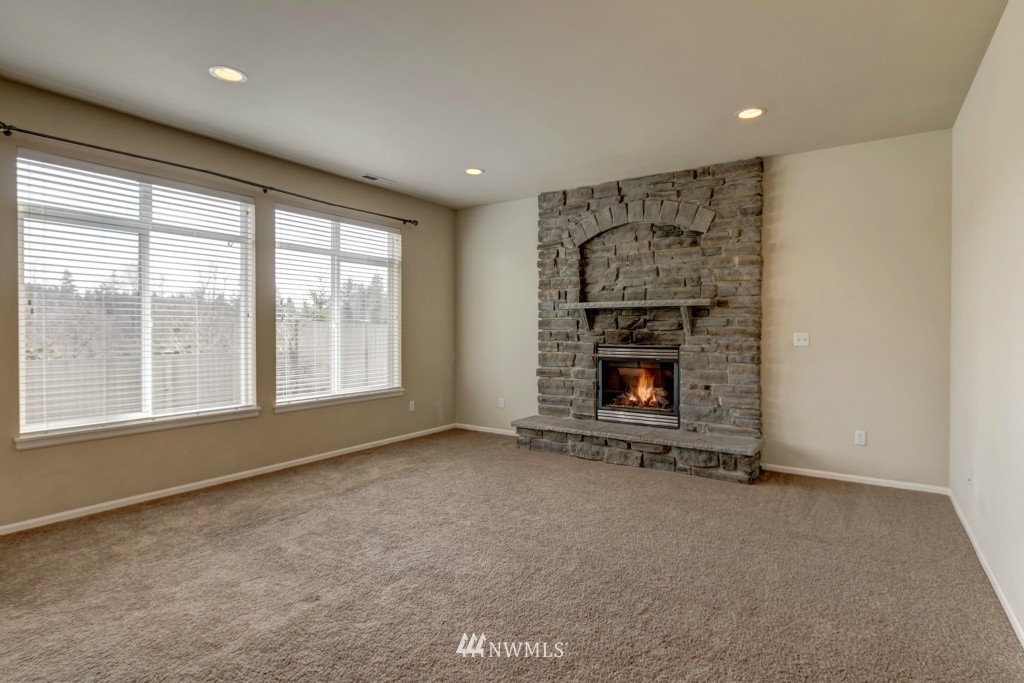 16123 35th Drive Southeast Bothell, WA 98012 - Photo 3 of 13 an empty room with a fireplace and window