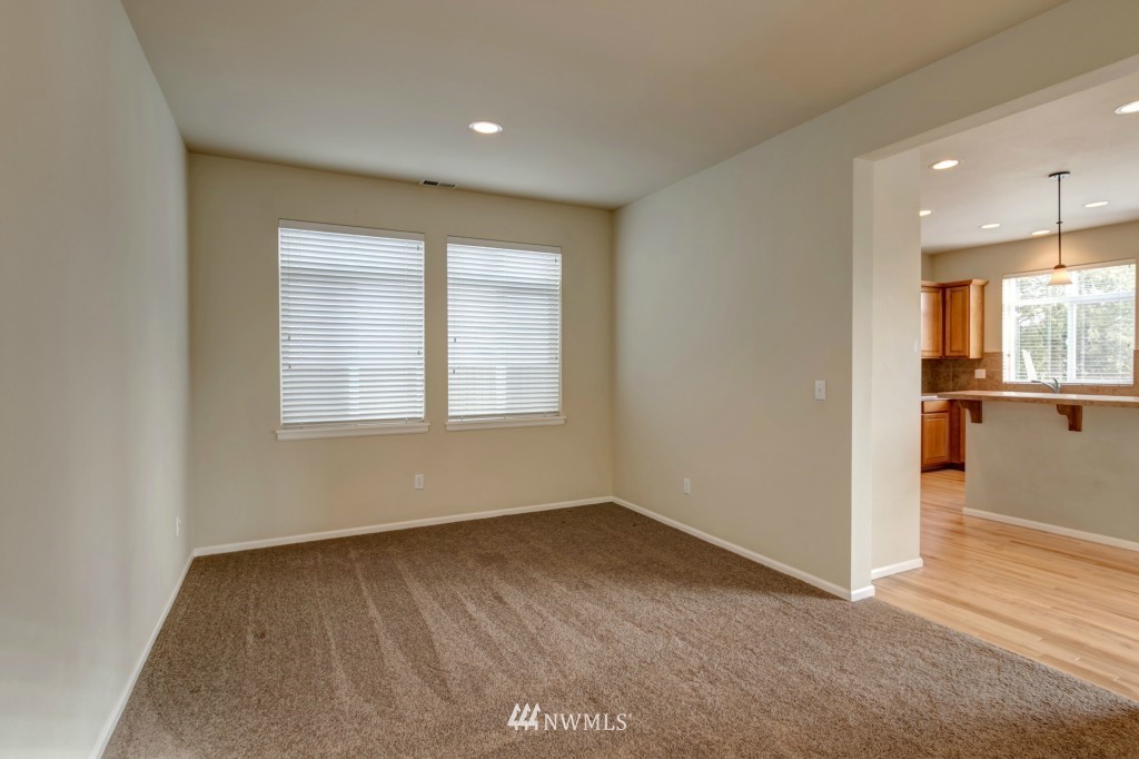 16123 35th Drive Southeast Bothell, WA 98012 - Photo 4 of 13 an empty room with wooden floor and windows