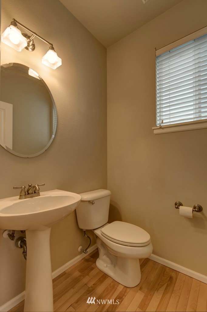 16123 35th Drive Southeast Bothell, WA 98012 - Photo 9 of 13 a white toilet sitting next to a bathroom sink