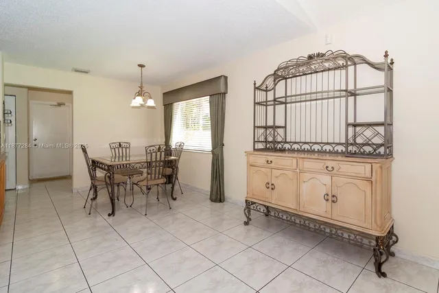 a view of a kitchen with kitchen island table and chairs