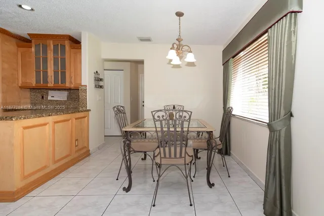 a view of a dining room with furniture and a chandelier