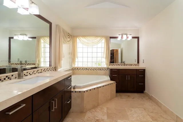 a spacious bathroom with a double vanity sink mirror and double