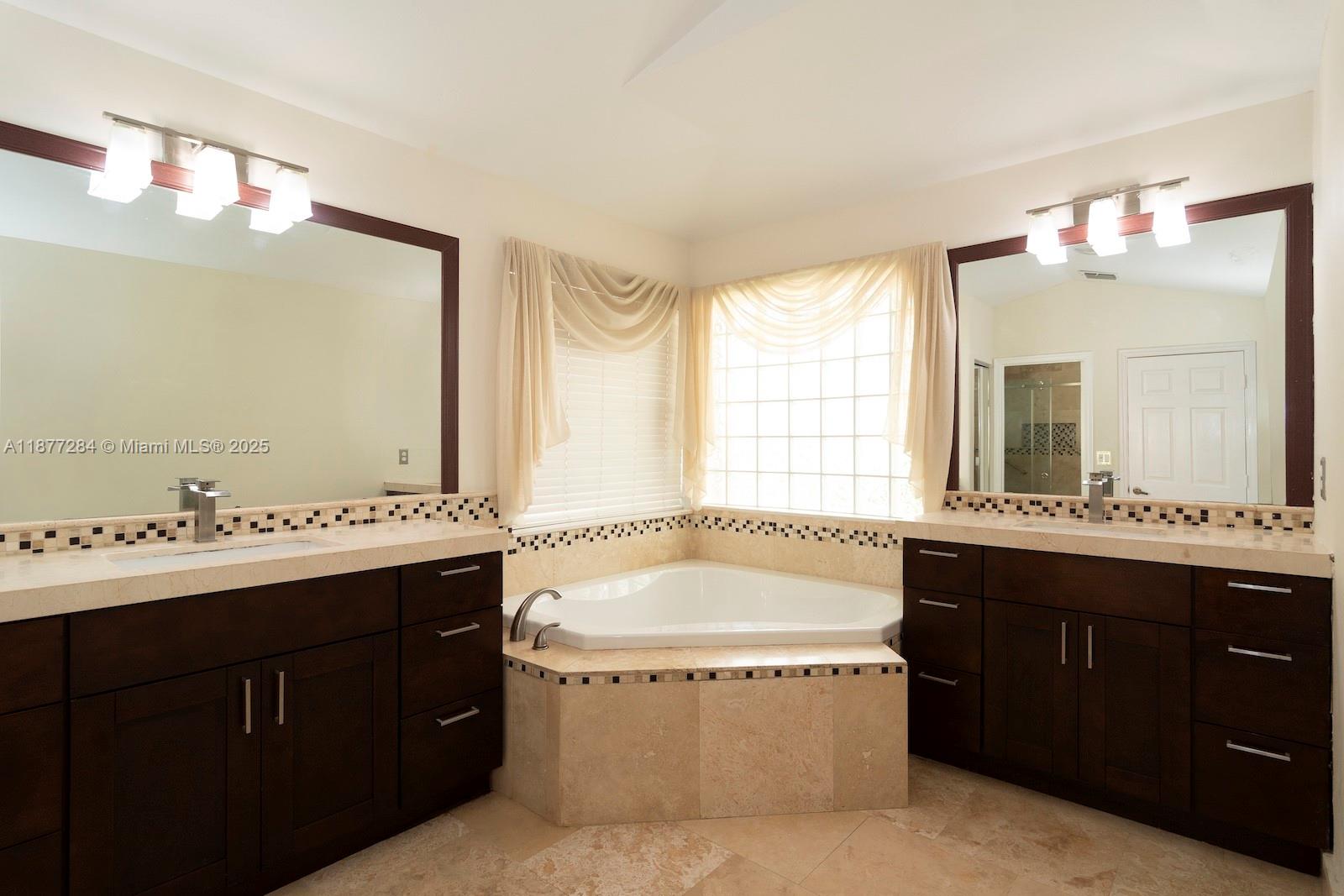 2293 Southwest 182nd Way Miramar, FL 33029 - Photo 20 of 41 a bathroom with a tub sink shower and mirror