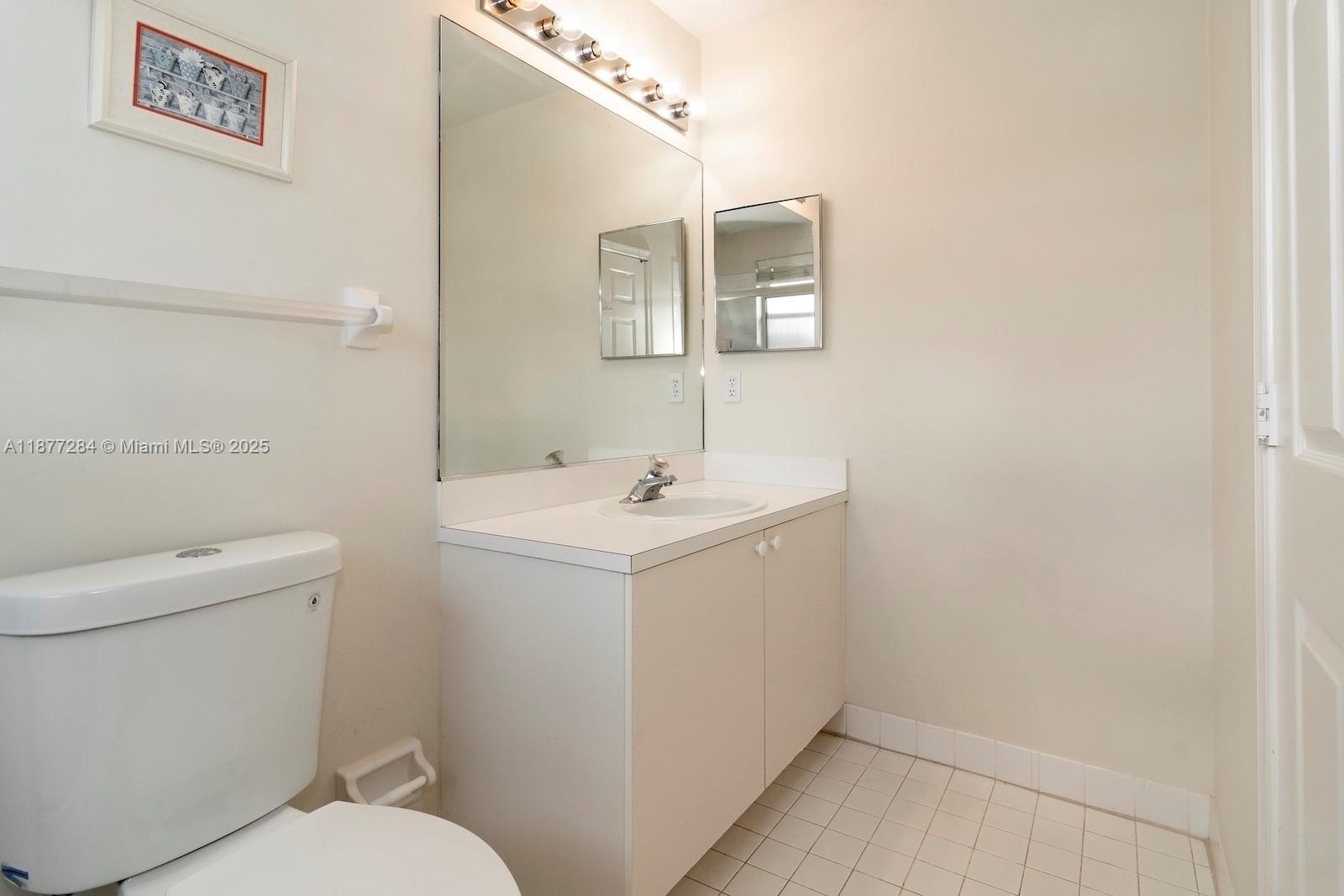 2293 Southwest 182nd Way Miramar, FL 33029 - Photo 30 of 41 a bathroom with a sink mirror and toilet