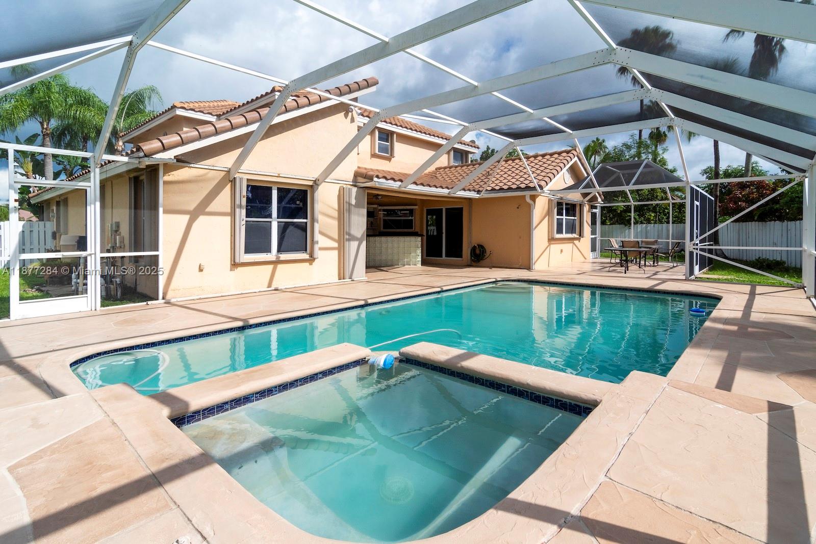 2293 Southwest 182nd Way Miramar, FL 33029 - Photo 36 of 41 a view of a white building with a swimming pool