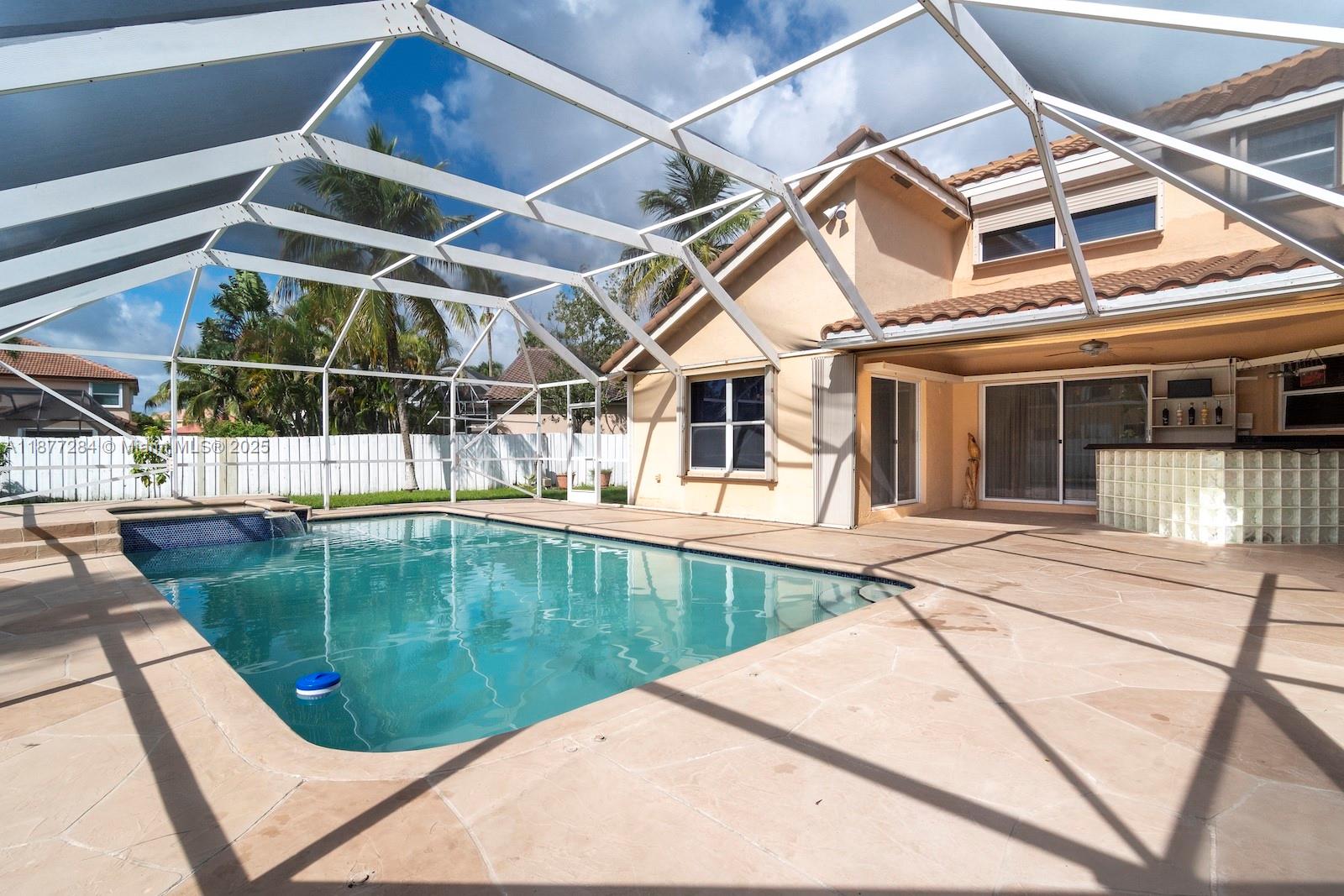 2293 Southwest 182nd Way Miramar, FL 33029 - Photo 37 of 41 a view of a swimming pool with a patio