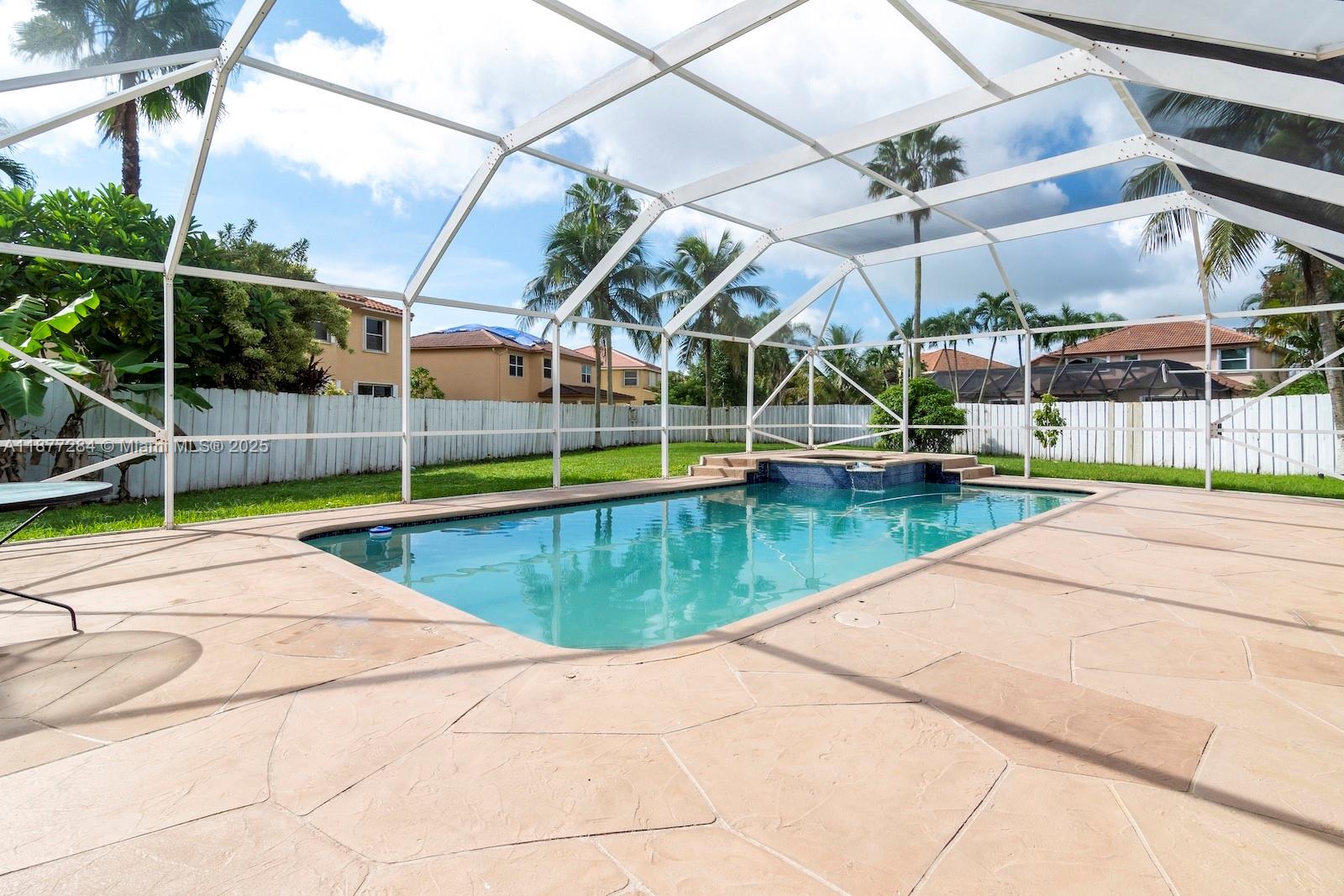 2293 Southwest 182nd Way Miramar, FL 33029 - Photo 38 of 41 a view of a swimming pool with a patio and a yard
