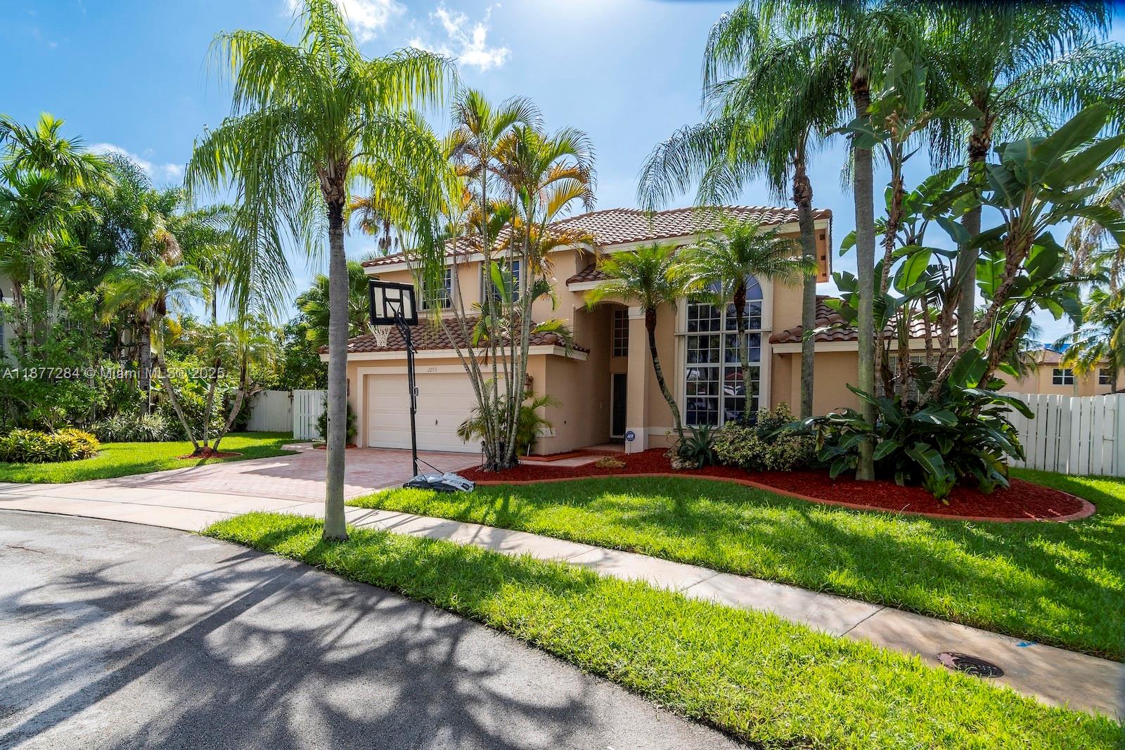 2293 Southwest 182nd Way Miramar, FL 33029 - Photo 4 of 41 a view of a house with a yard and palm trees