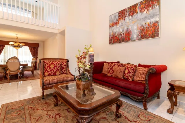 a living room with furniture a rug and a wall painting