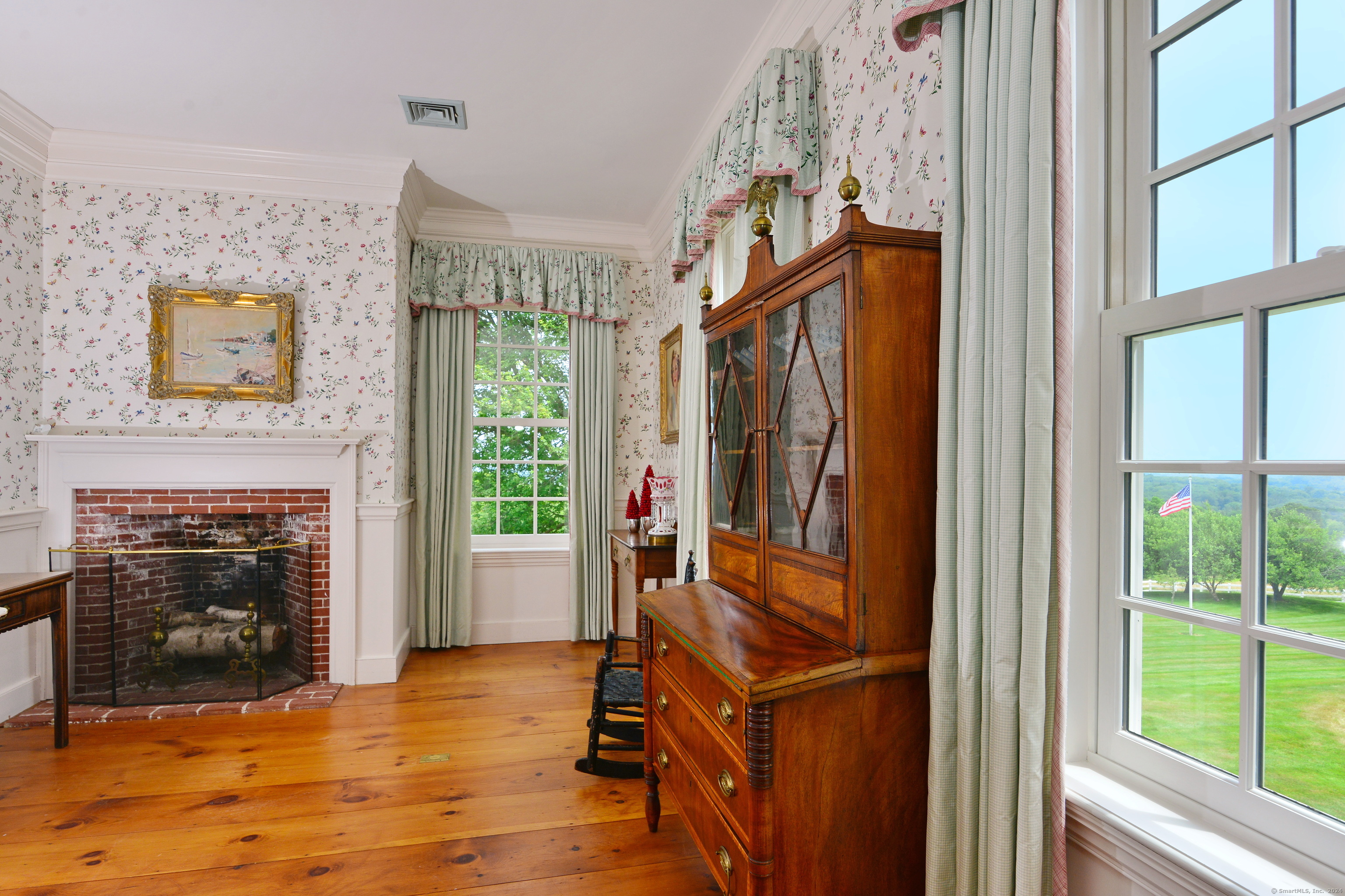 175 Pulpit Rock Road Woodstock, CT 06281 - Photo 23 of 39 The sitting room in the three-room primary suite is warmed by a fireplace and natural light.