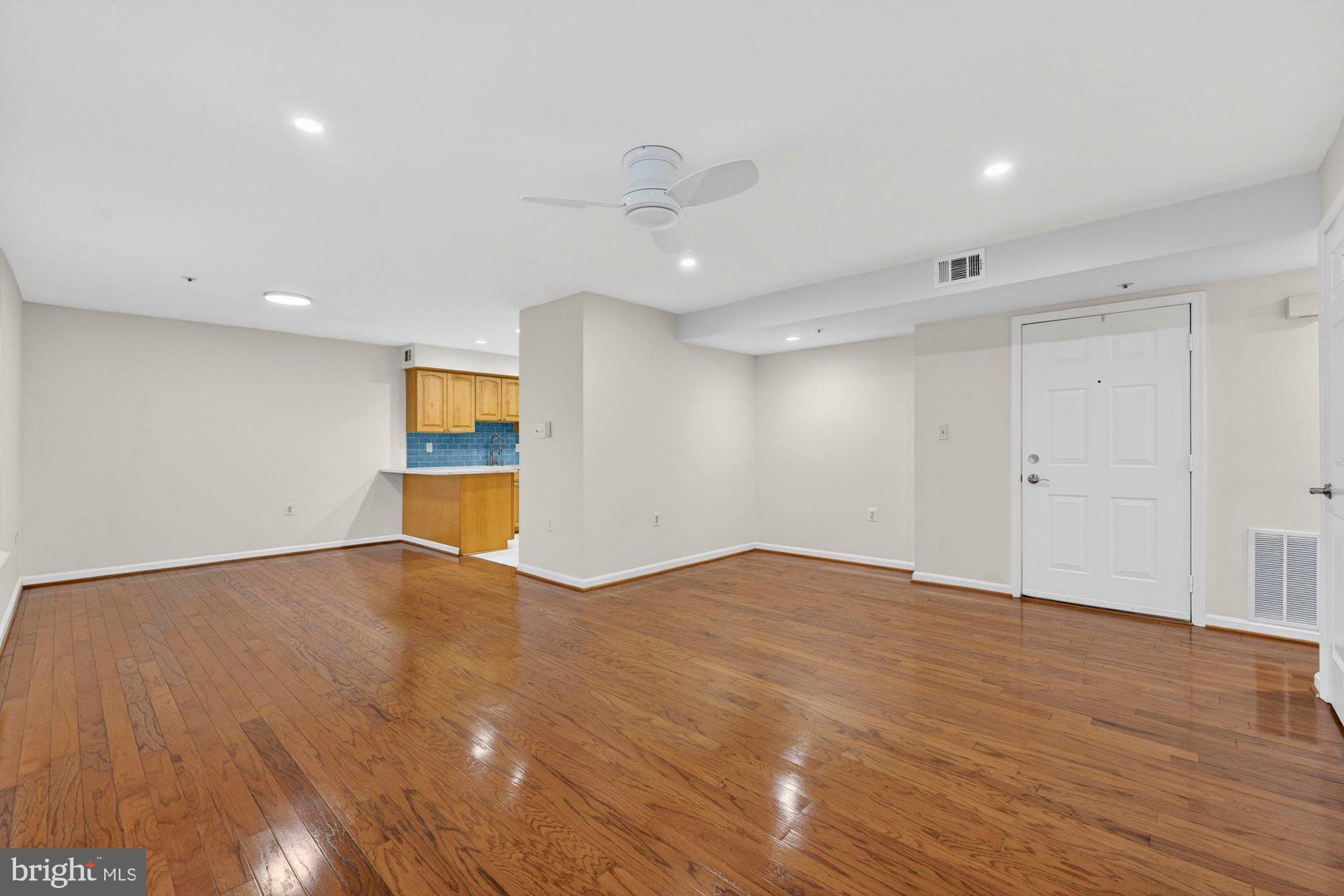 207 Park Street Vienna, VA 22180 - Photo 11 of 45 a view of an empty room with wooden floor and a window
