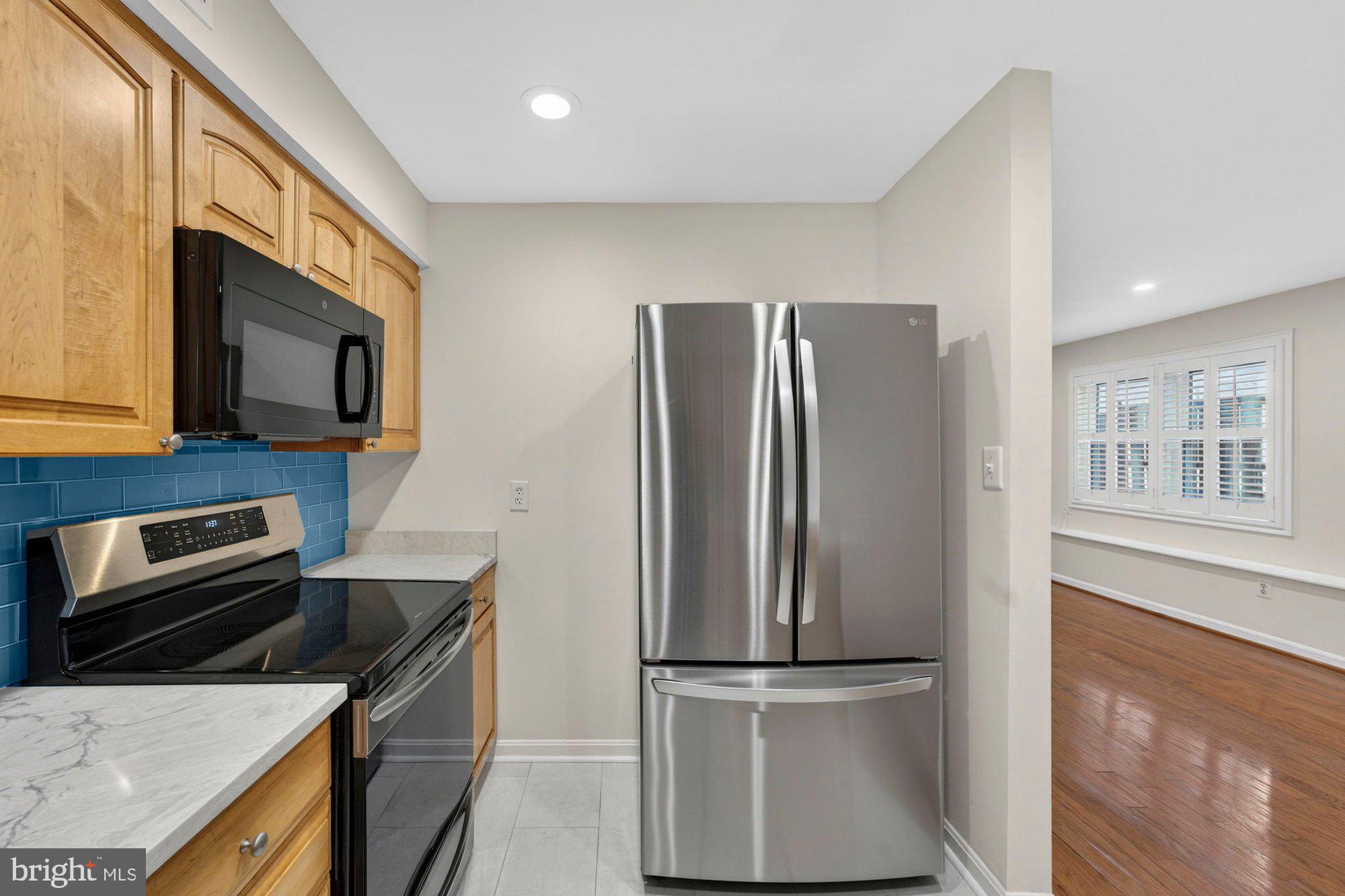 207 Park Street Vienna, VA 22180 - Photo 14 of 45 a kitchen with stainless steel appliances granite countertop a refrigerator a stove and a microwave