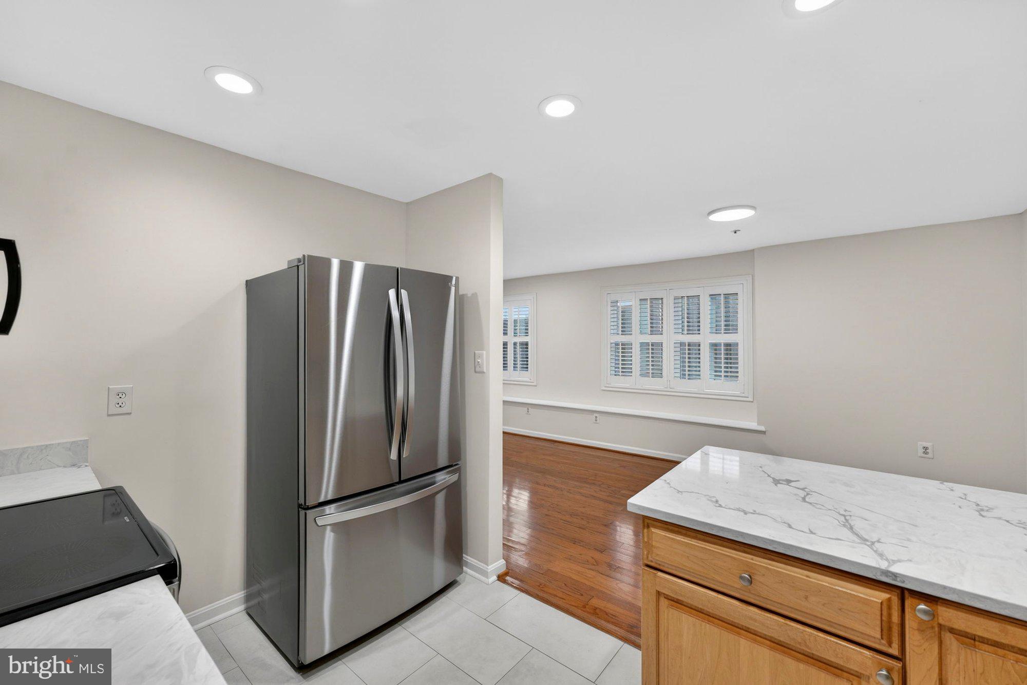 207 Park Street Vienna, VA 22180 - Photo 15 of 45 a kitchen with a refrigerator and a stove top oven