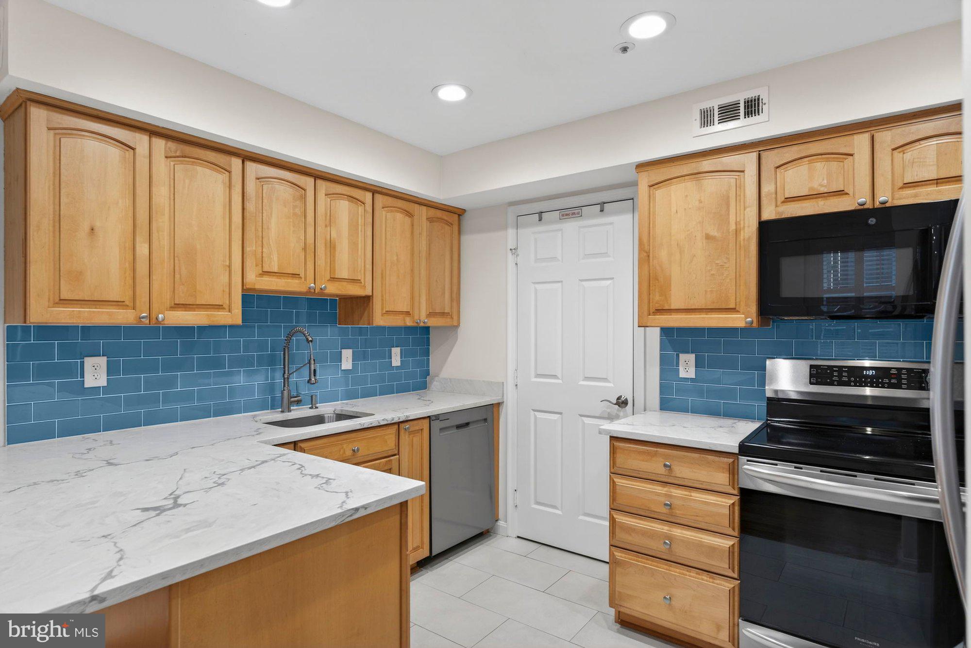 207 Park Street Vienna, VA 22180 - Photo 16 of 45 a kitchen with stainless steel appliances granite countertop a sink and a stove