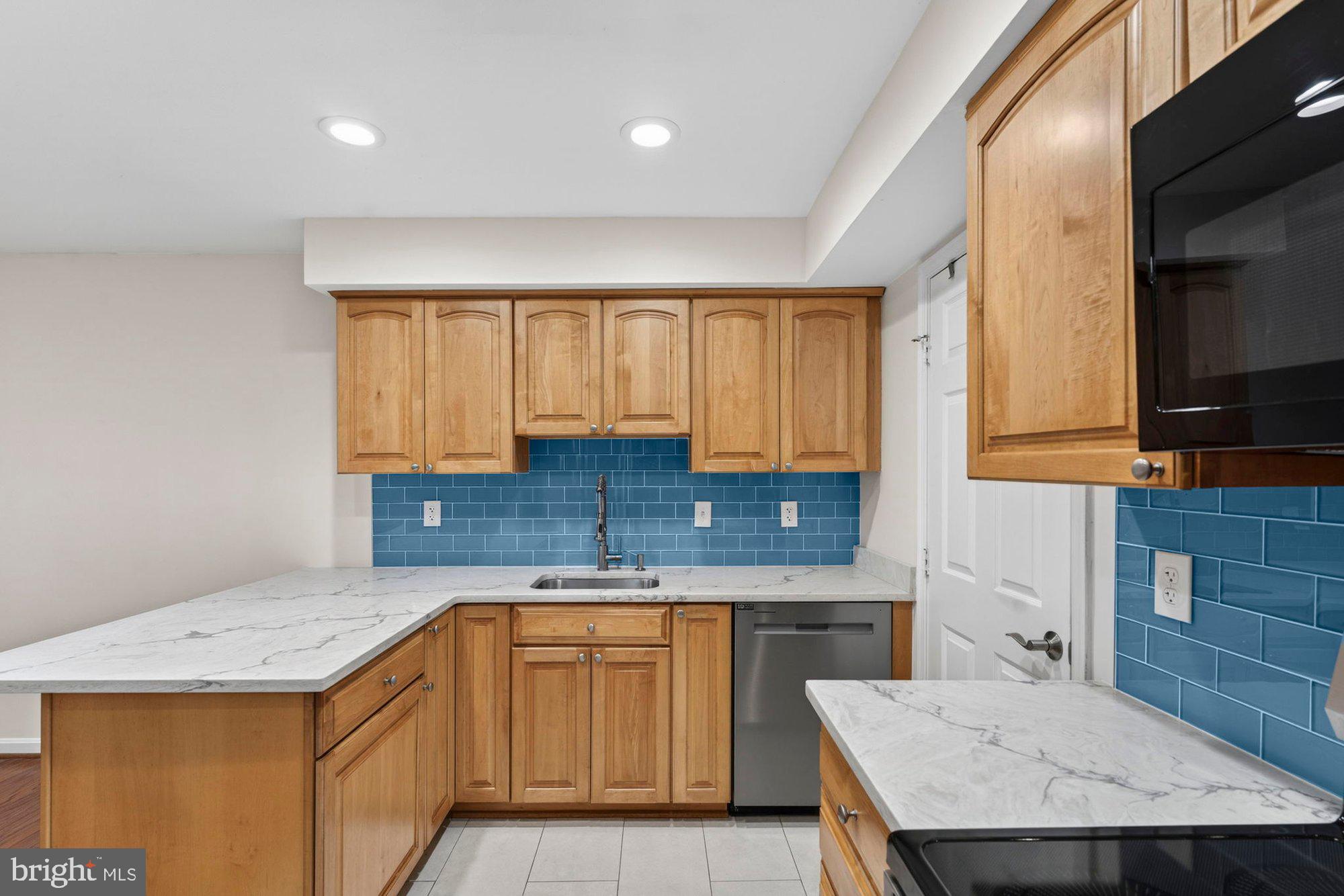 207 Park Street Vienna, VA 22180 - Photo 18 of 45 a kitchen with a stove a sink a microwave a counter top space and cabinets