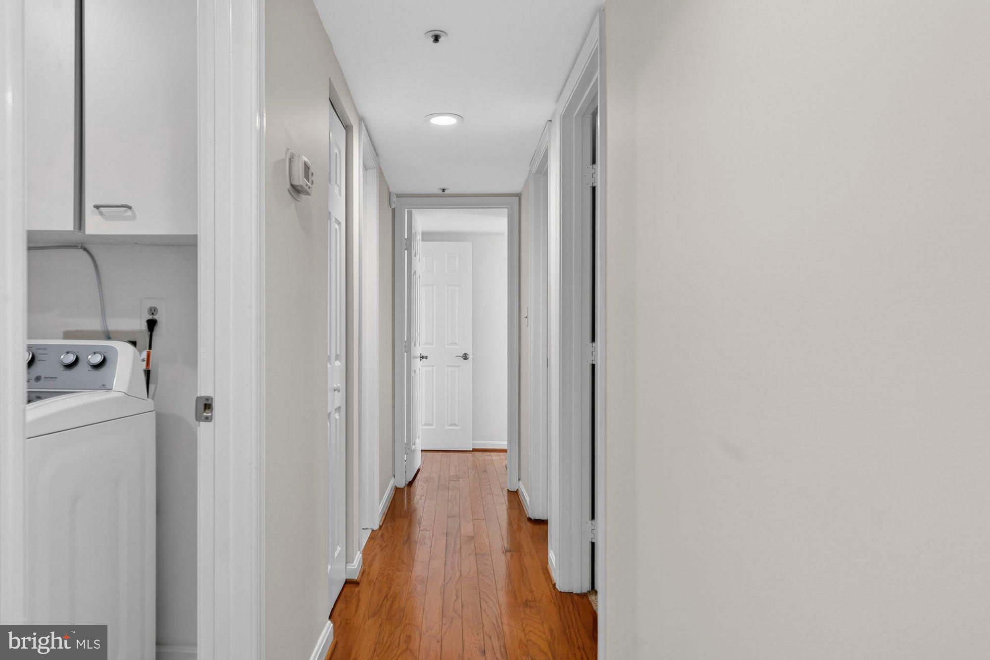 207 Park Street Vienna, VA 22180 - Photo 19 of 45 a view of a hallway with closet and wooden floor
