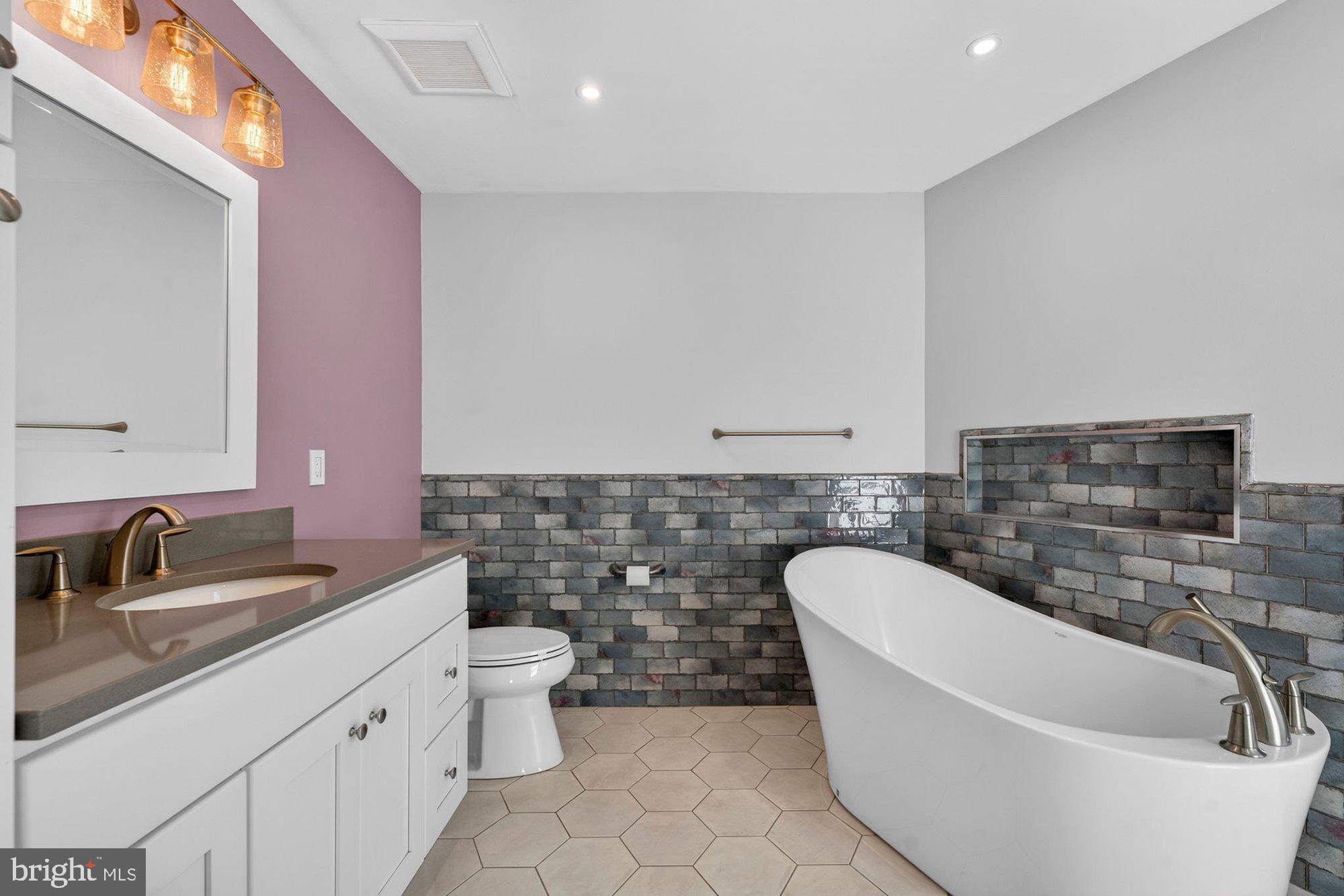 207 Park Street Vienna, VA 22180 - Photo 25 of 45 a bathroom with a sink a toilet and mirror