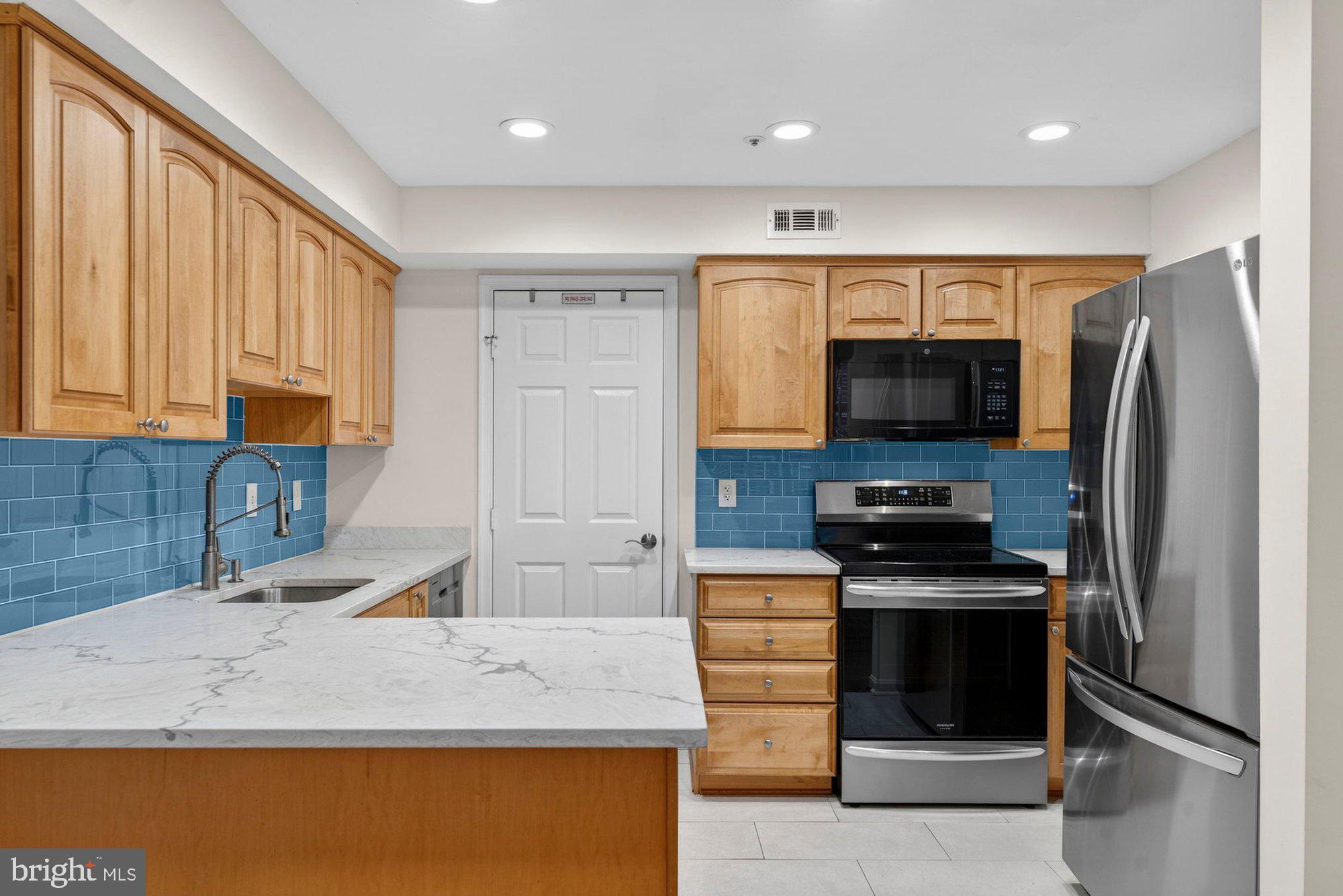 207 Park Street Vienna, VA 22180 - Photo 3 of 45 a kitchen with granite countertop a refrigerator and a sink